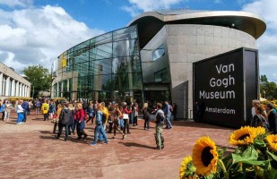 Front view of the Von Gogh museum. Visitors standing in front of the musuen in Amsterdam, Netherlands.