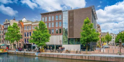 The Anne Frank house museum with some tourists waiting to enter. Amsterdam, Netherlands.